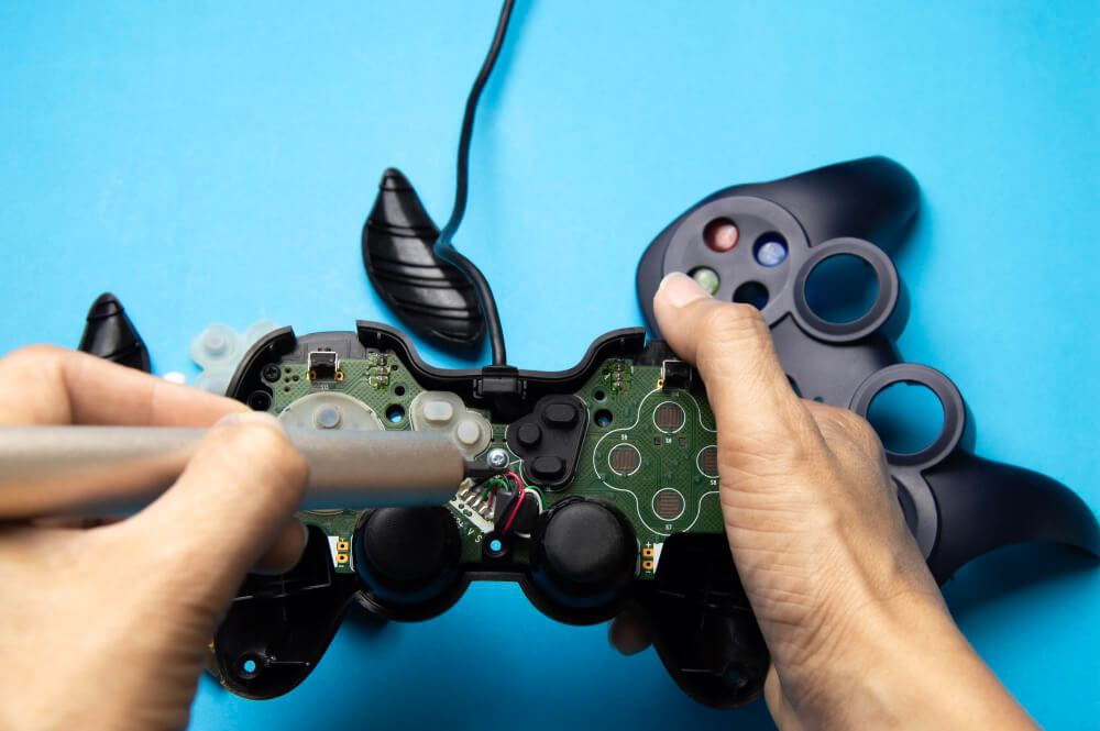Technician repairing the internal components of a game controller
