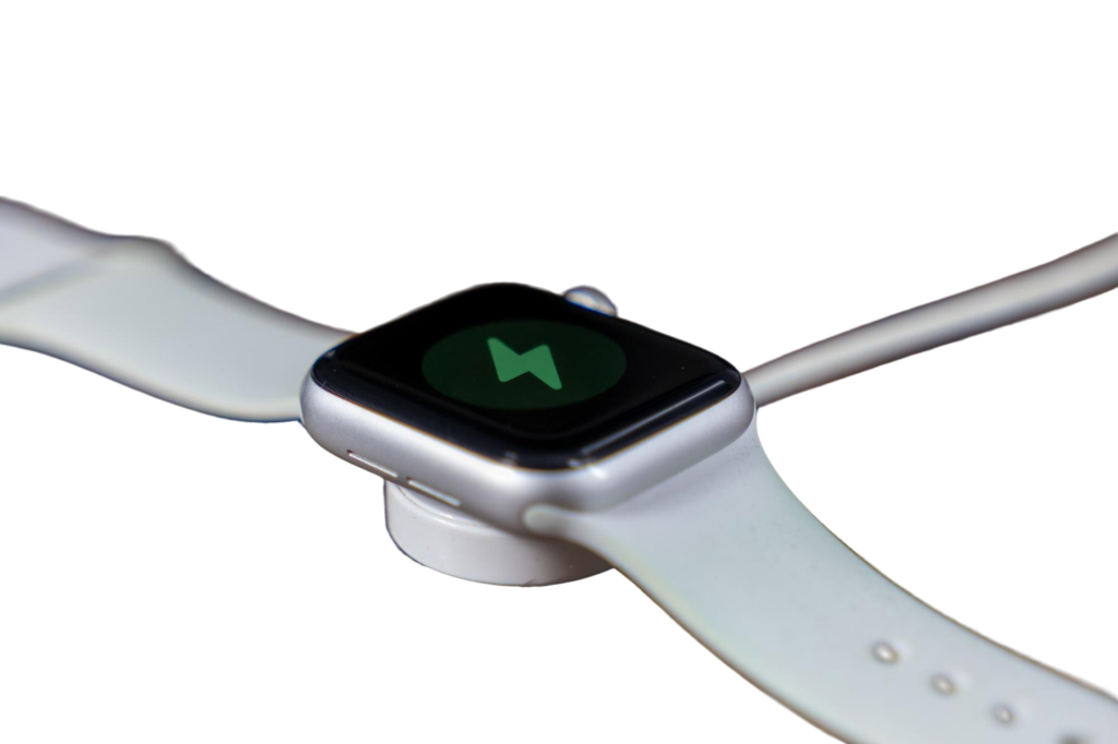 smartwatch charging wireless dock with white strap wooden surface